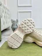 Gucci unisex off-white sneaker outsole view with tread and branding on the heel