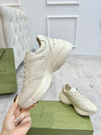 Cream Gucci unisex lace-up sneakers with padded collar and thick platform sole.