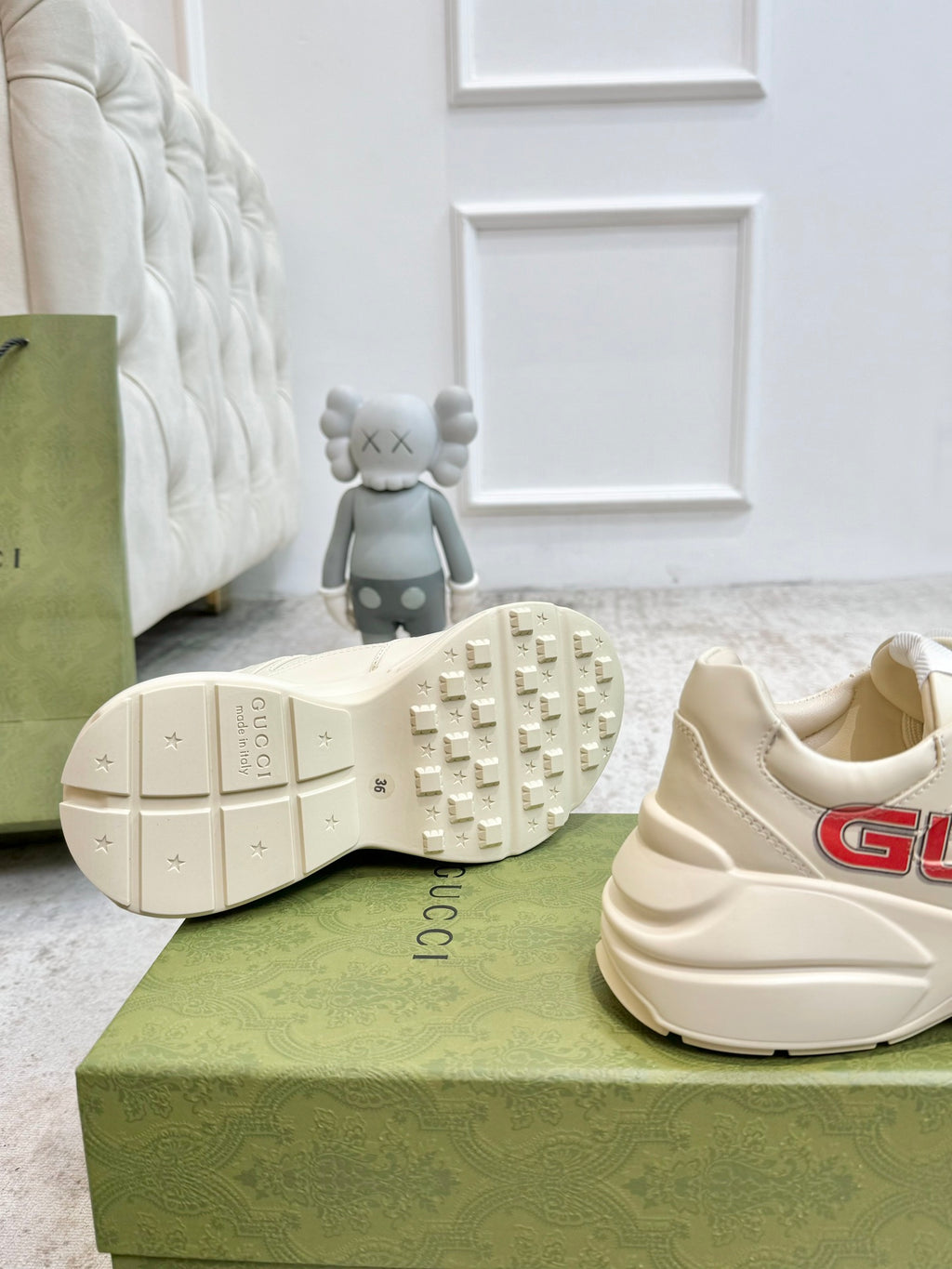 Cream Gucci unisex sneakers with textured tread outsole and rear logo detail.