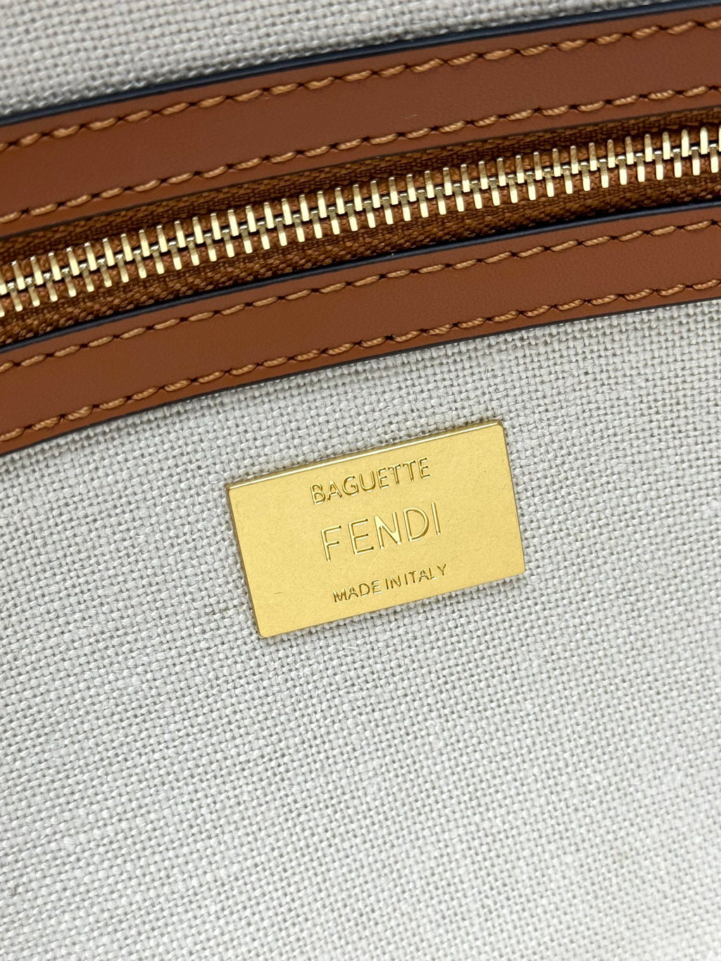 Beige canvas interior with gold FENDI label and MADE IN ITALY text