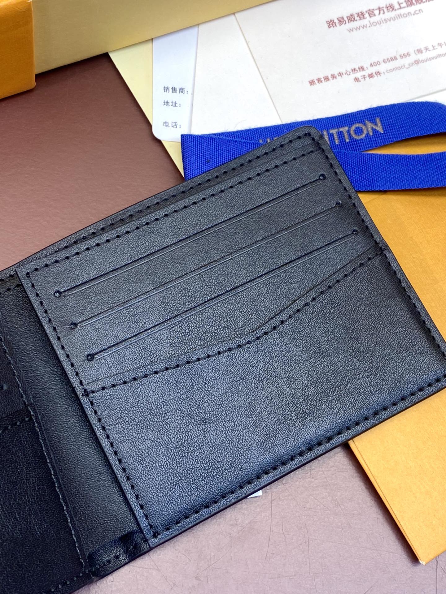 Small leather wallet cardholder interior with multiple slots, stitched seam