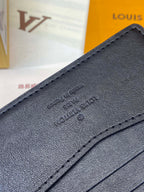 Small leather wallet close-up with embossed logo and stitched trim