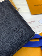 Small leather wallet corner with embossed LV-style logo, textured finish