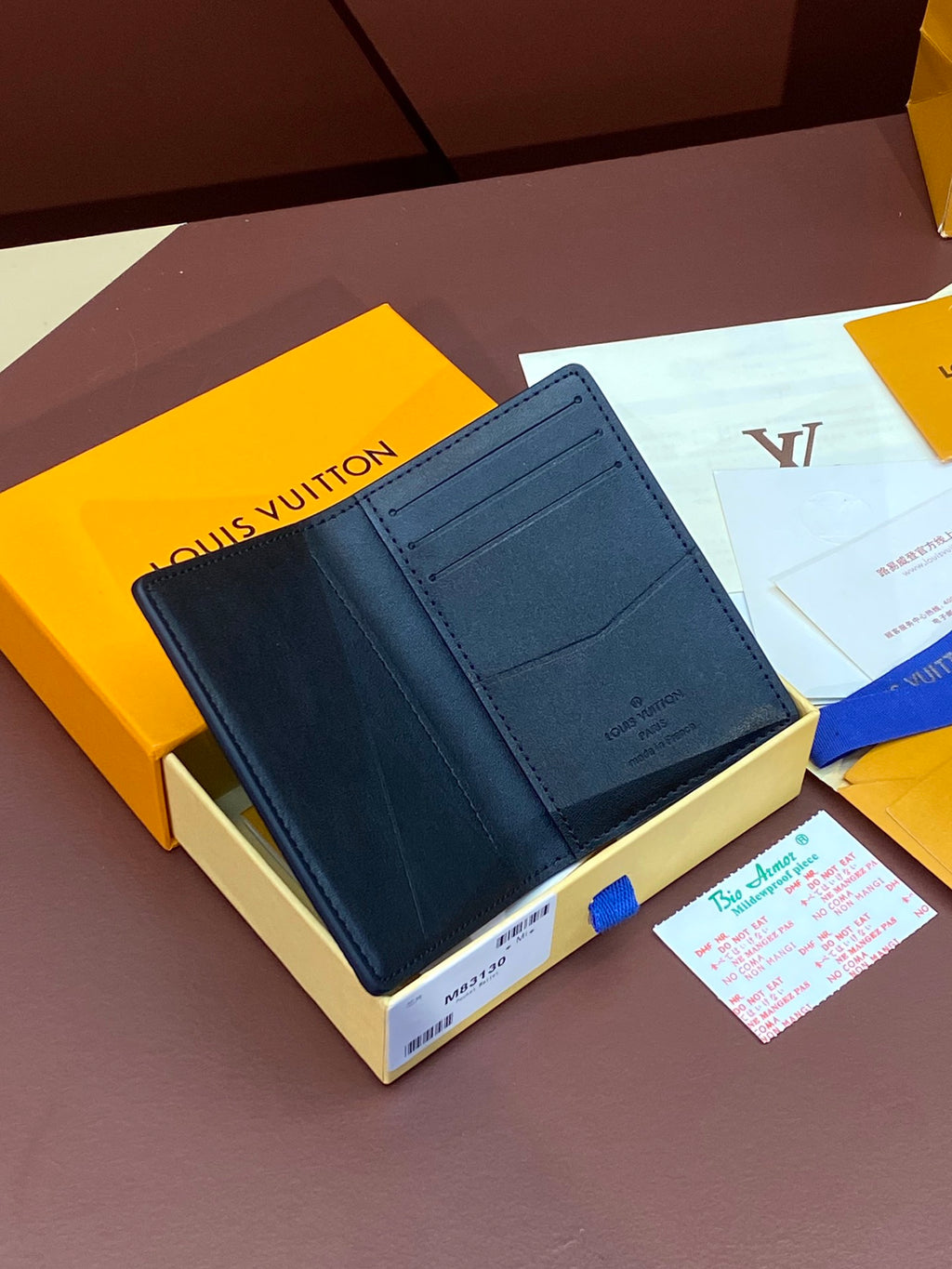 Dark blue leather small wallet with stitched card panels and LV logo