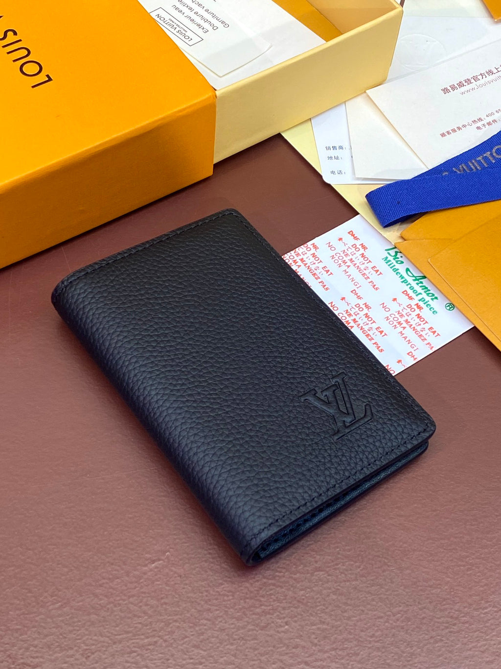 Dark blue leather small wallet with embossed LV logo, front view