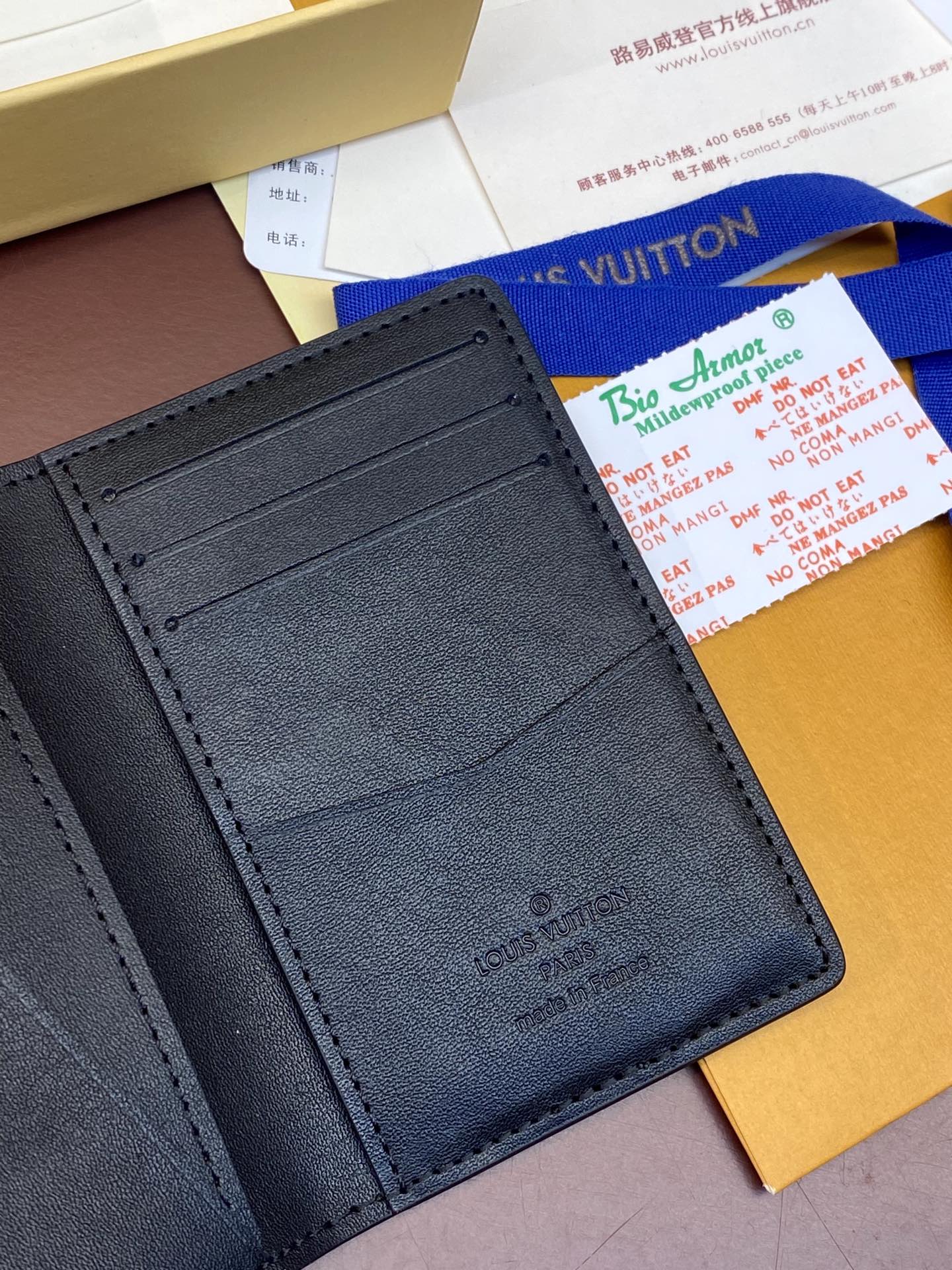 Dark blue leather wallet interior with stitched card slots and LV stamp