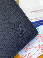 Dark blue leather wallet corner with embossed LV logo detail