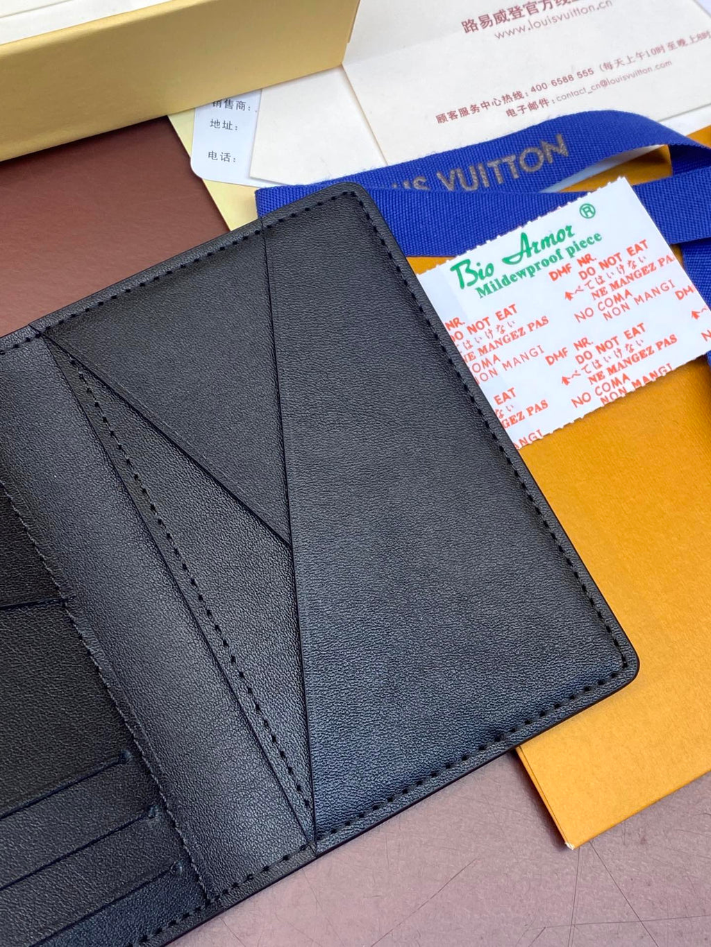 Dark blue leather wallet interior showing card compartments and seams