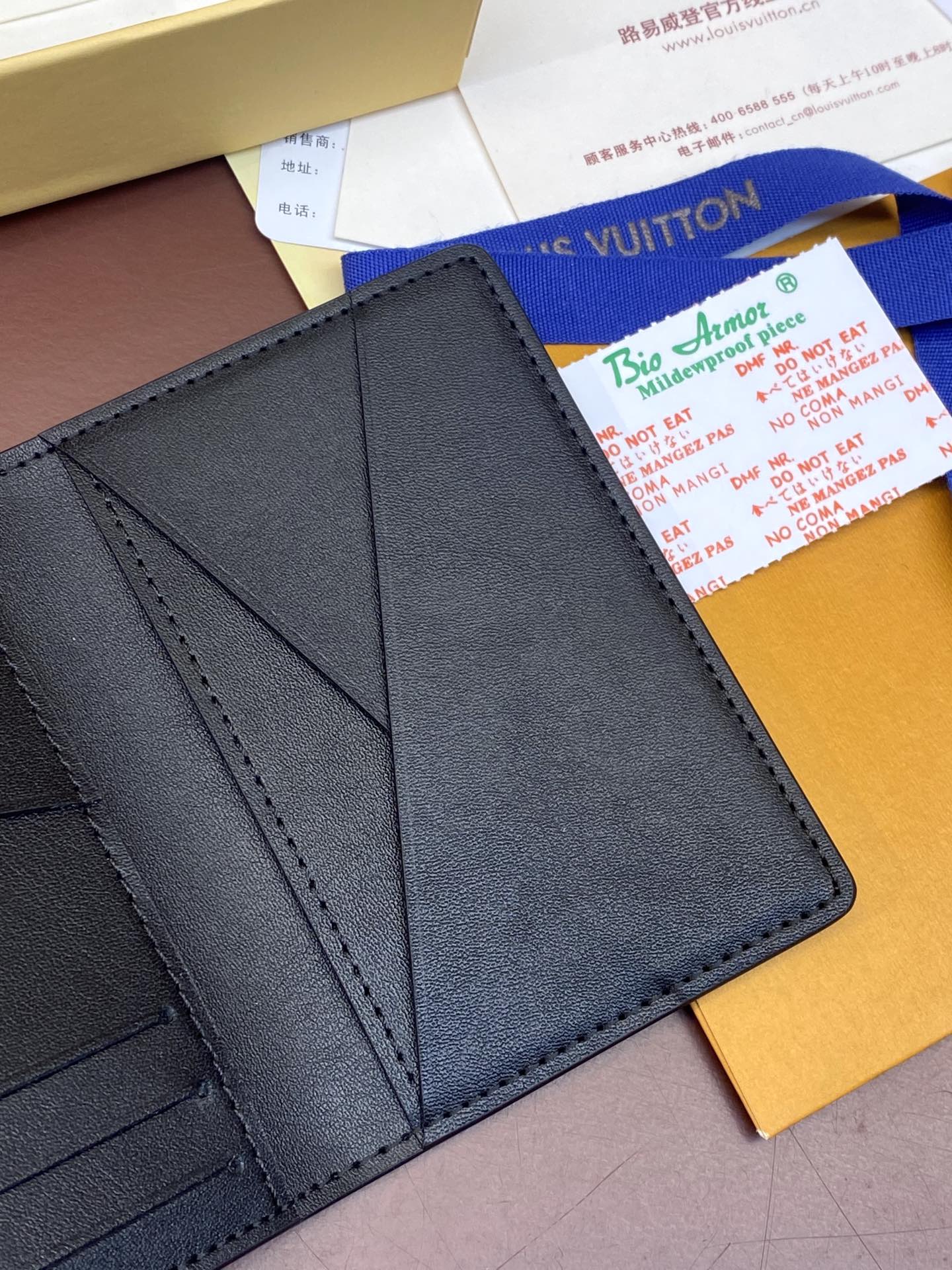 Dark blue leather wallet interior showing card compartments and seams