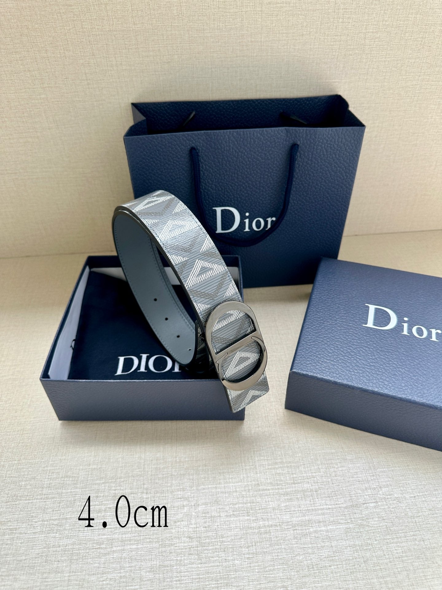 Dior belt with blue strap, patterned strap panel, and oval buckle with holes