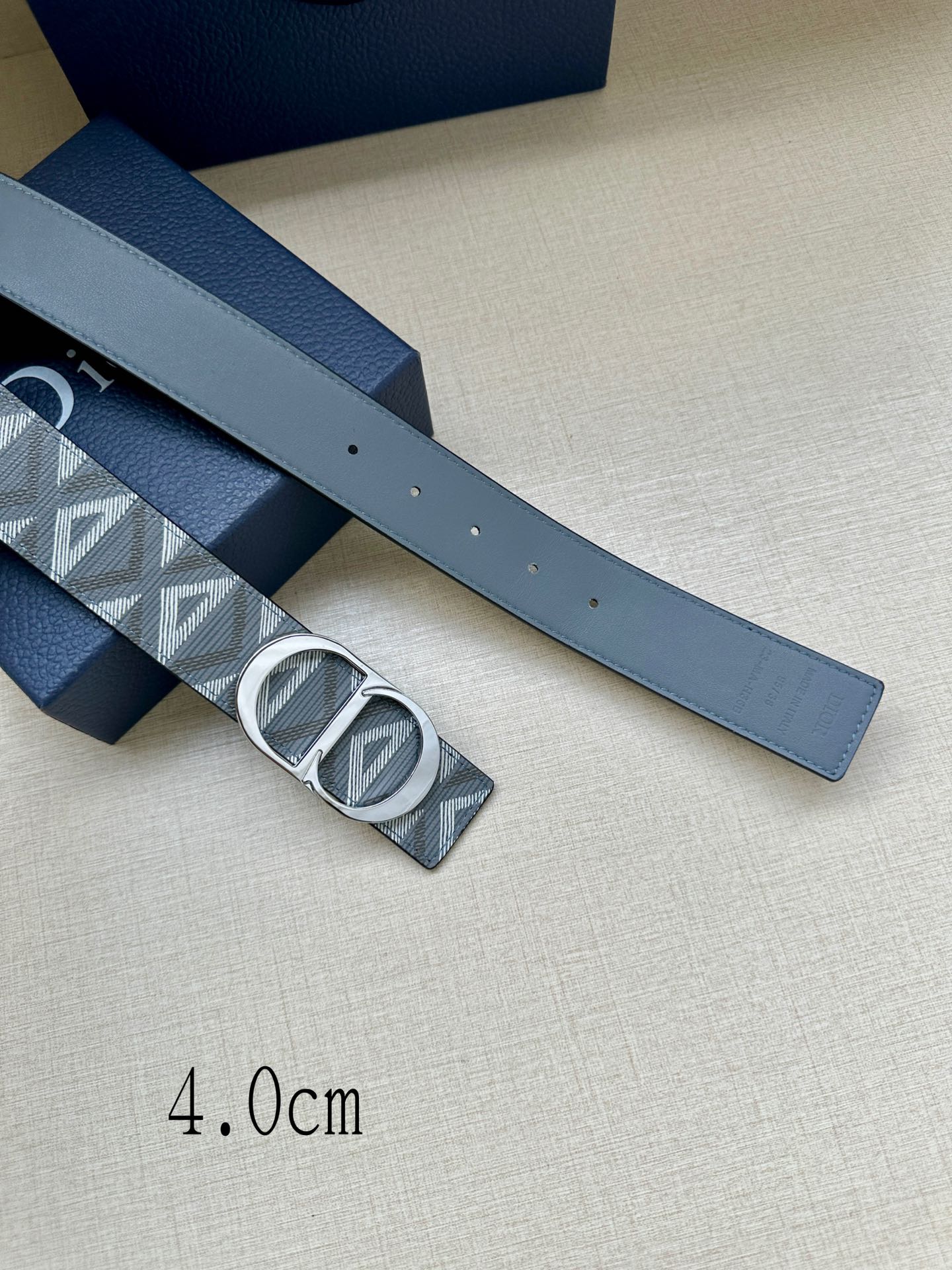 Dior belt wide strap with gray geometric pattern and oval logo buckle, belt holes