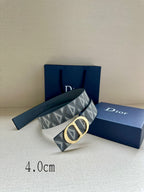 Designer belt by Dior with gray-blue monogram strap and gold CD buckle, angled.