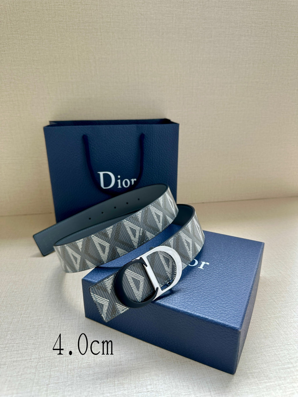 Logo-print belt with silver buckle and dark leather strap, angled view