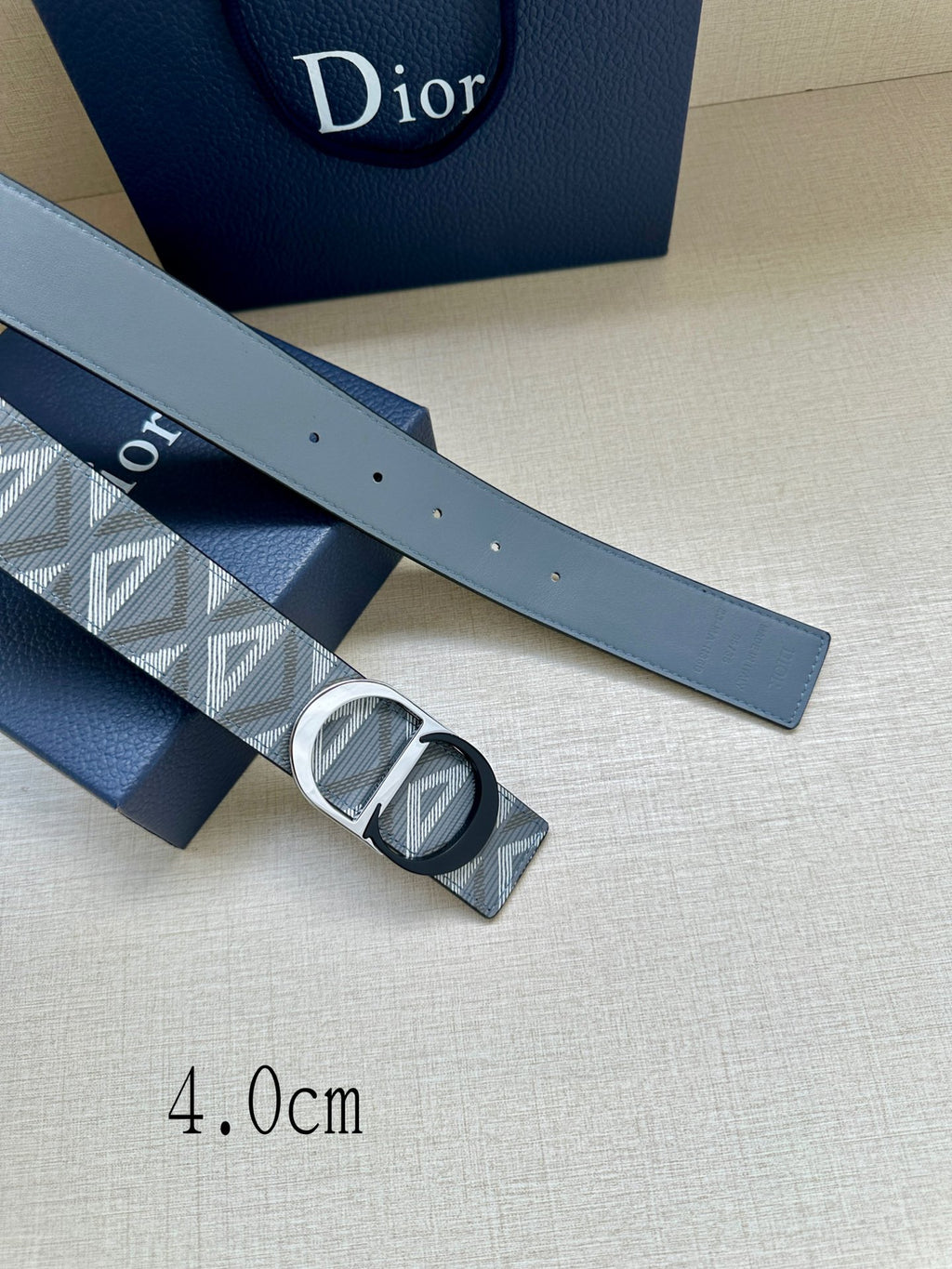 Logo-print belt strap with silver buckle detail and small perforations