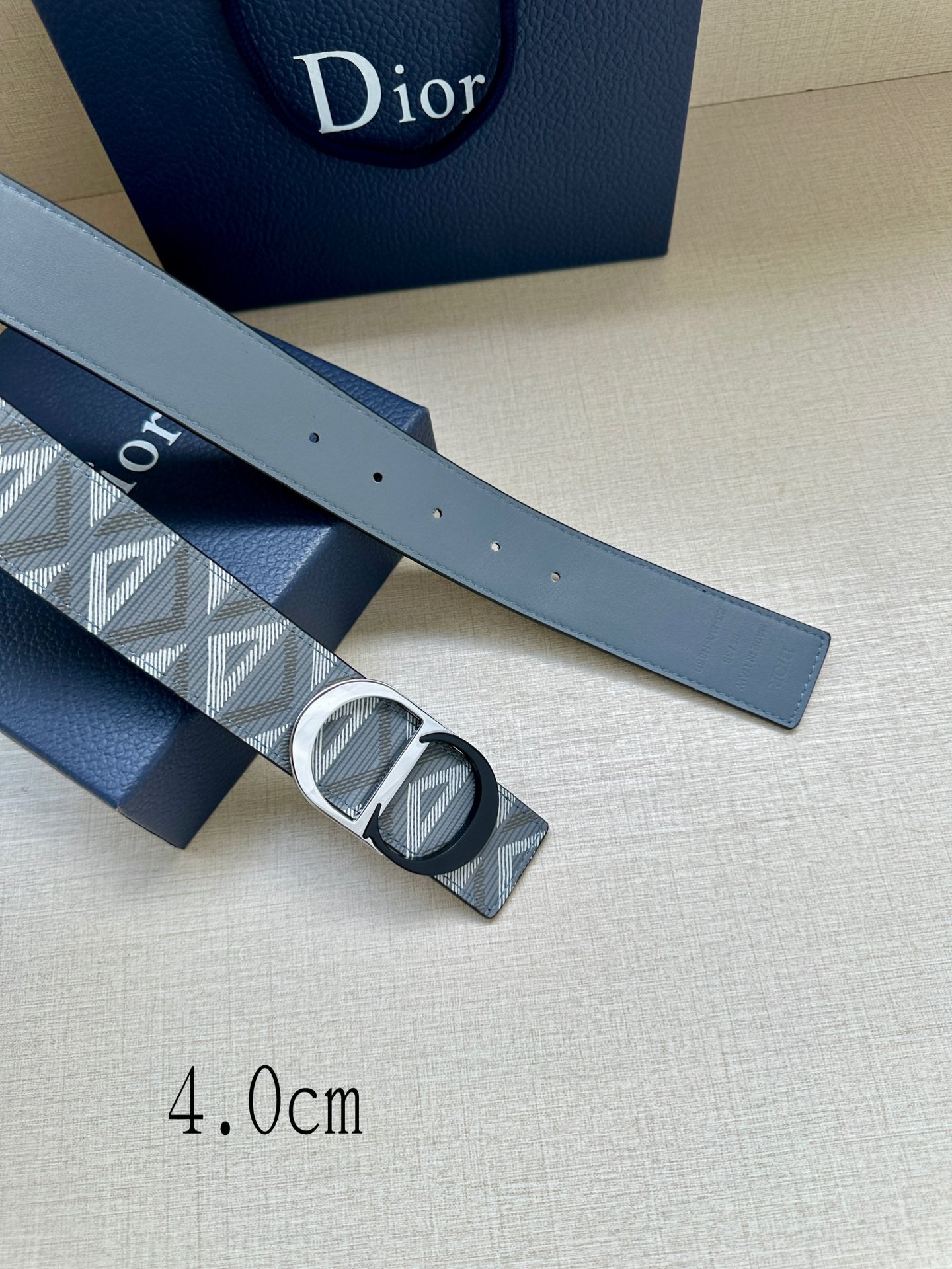 Logo-print belt strap with silver buckle detail and small perforations