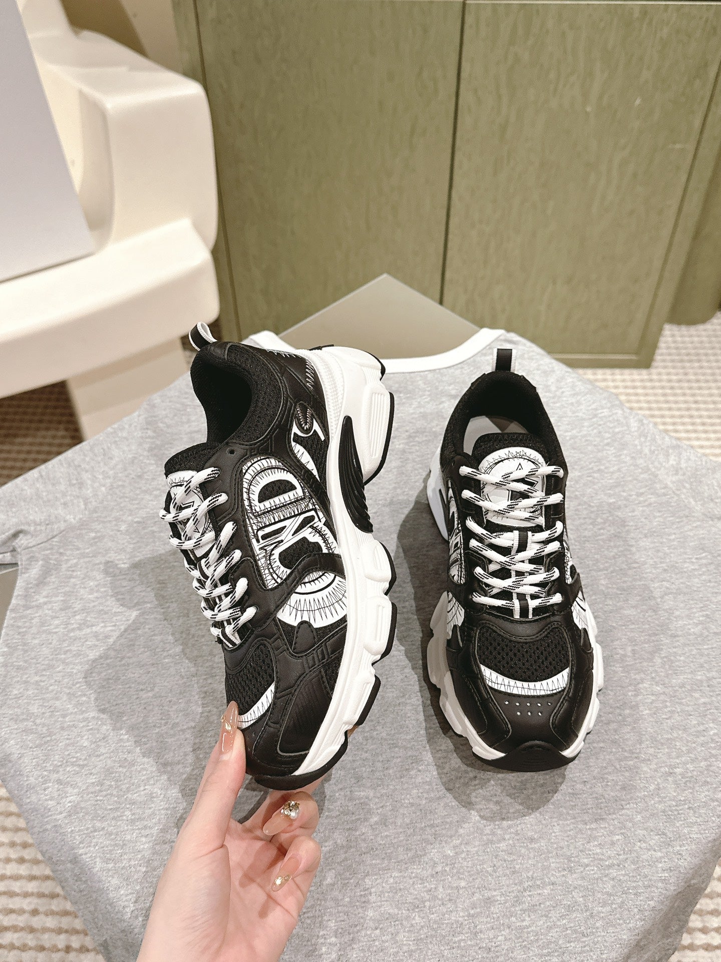 Unisex sneakers with black uppers, white accents, and lace-up front