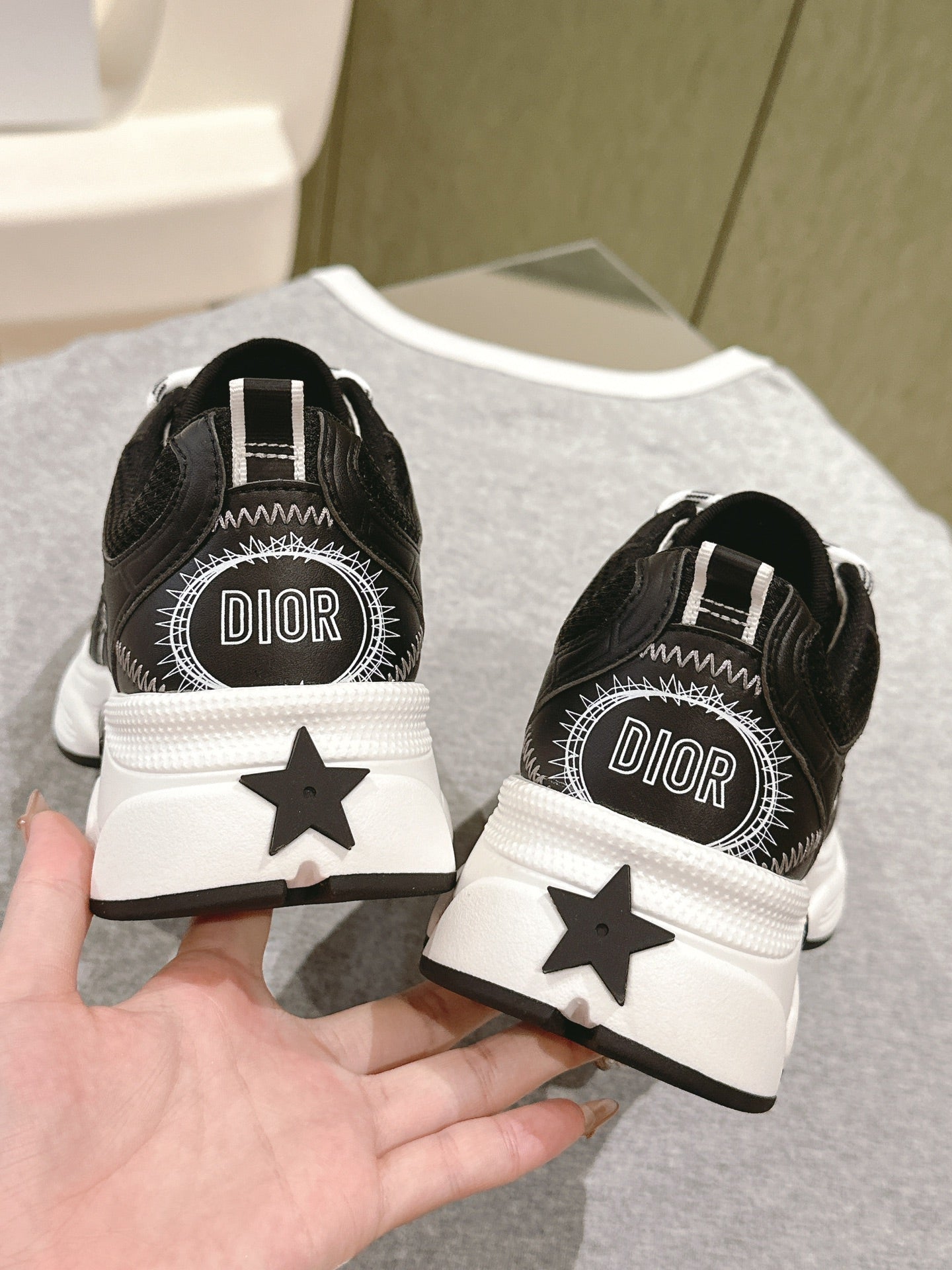 Unisex sneakers heel view with Dior logo, black and white star detail