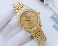 Rolex gold wristwatch with diamond bezel and gold-tone link bracelet, beige dial