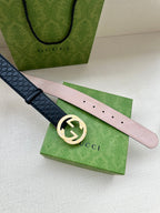 Dark blue leather belt with silver logo buckle and light pink underside strap