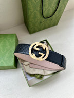 Dark blue leather belt with silver logo buckle over folded packaging materials