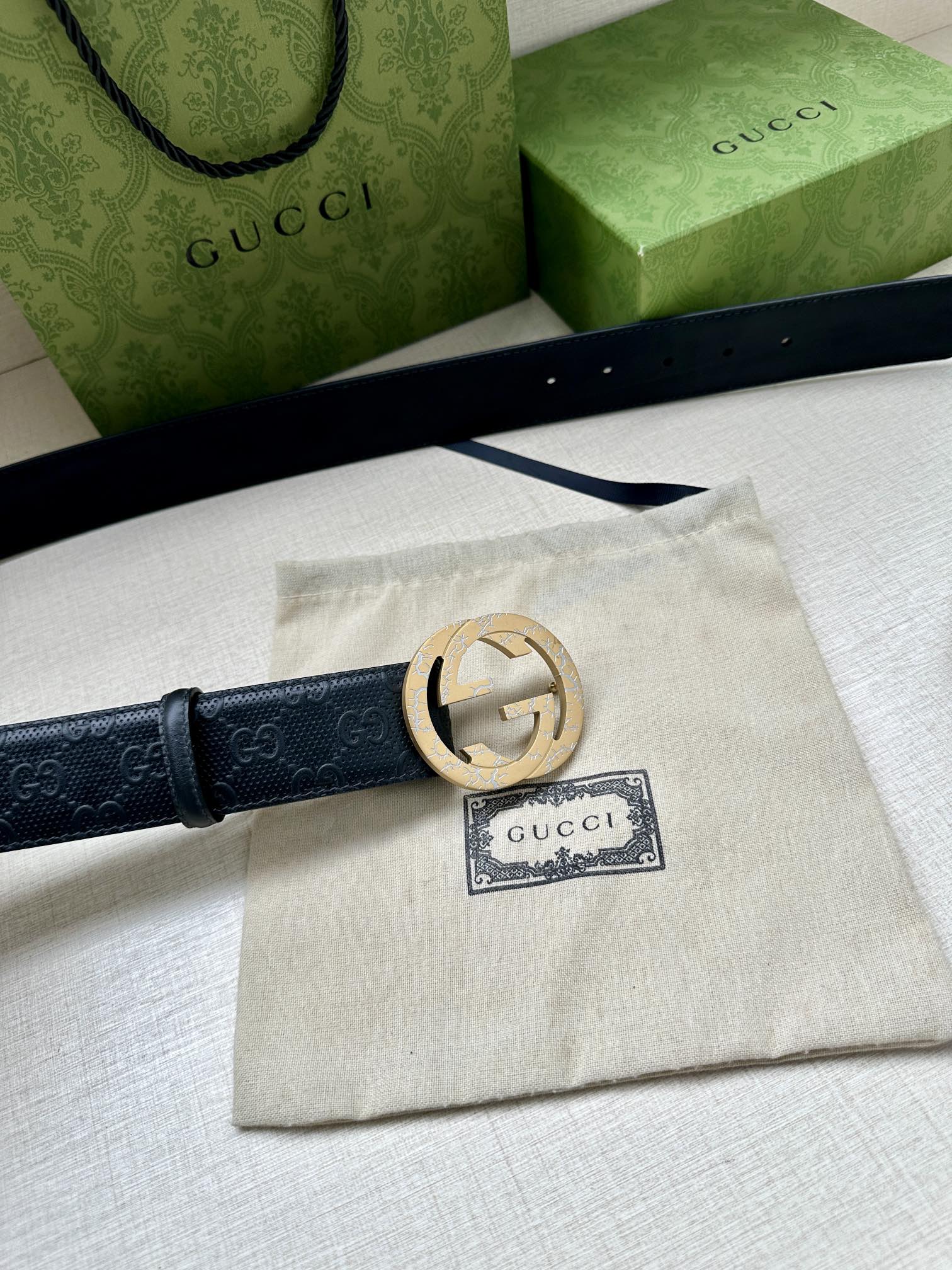 Dark blue Gucci belt with gold logo buckle and fabric dust bag