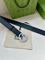 Dark blue leather belt with keeper strap and small logo tag