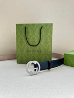 Gucci belt front view: dark navy GG embossed strap with silver-tone interlocking G buckle