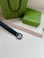 Gucci belt side view: dark navy leather with GG pattern, buckle and punched holes