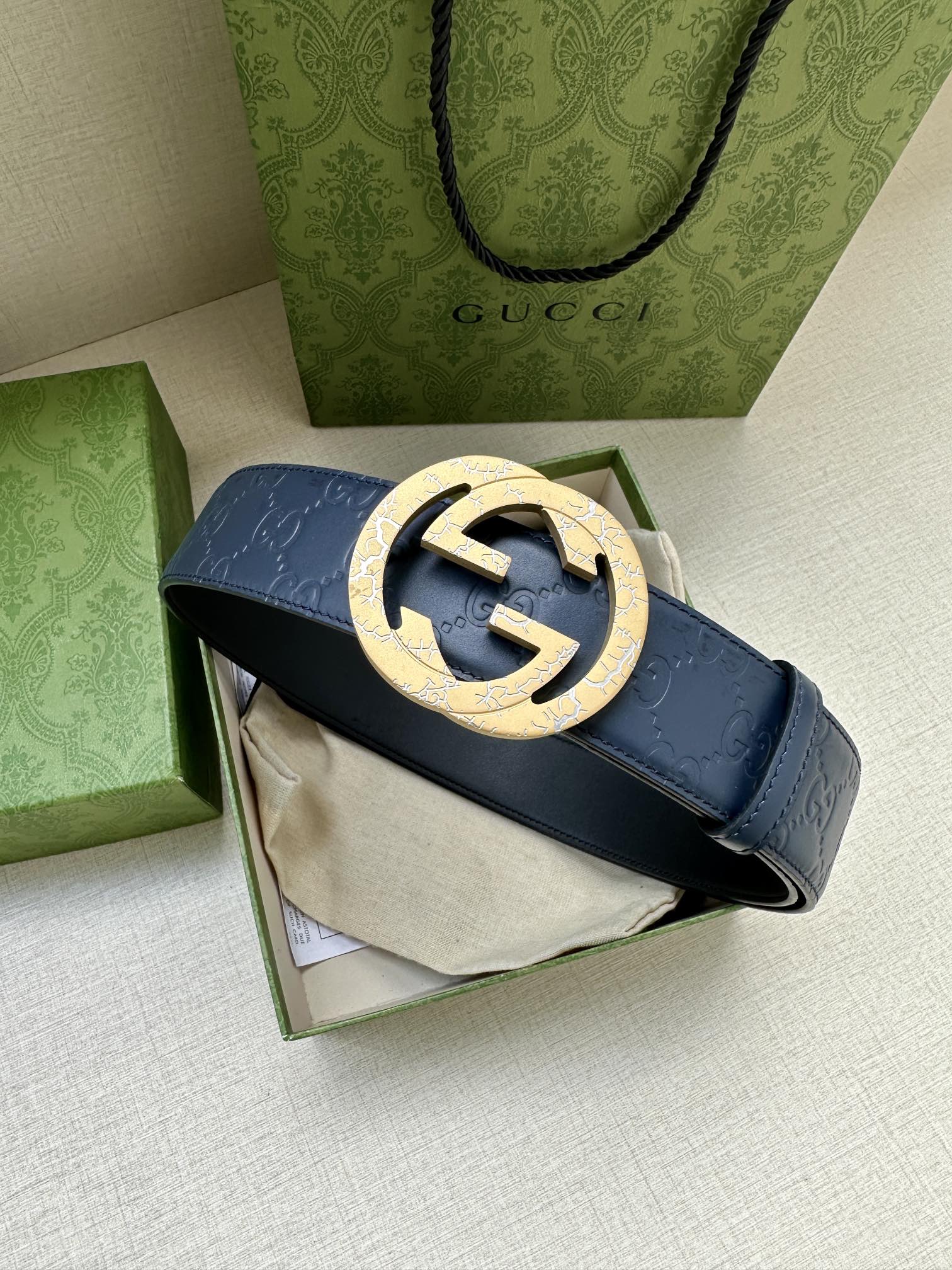 Gucci belt with dark blue strap and gold-tone GG buckle