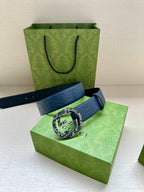 Gucci belt dark blue strap with round GG buckle and embossed logo pattern