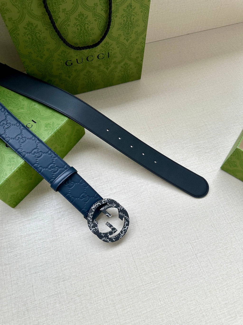 Gucci belt dark blue leather strap with embossed logo and adjustment holes
