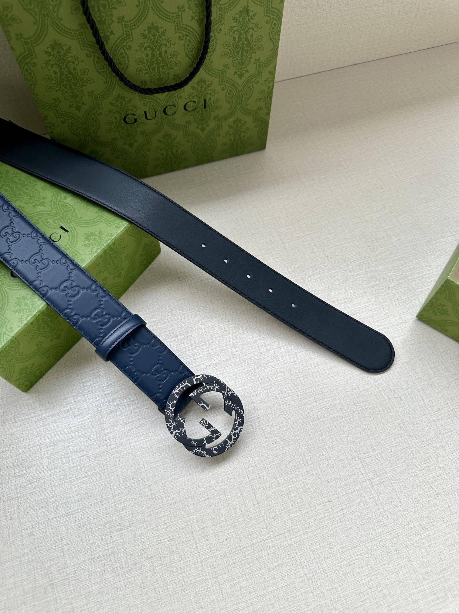 Gucci belt dark blue leather strap with embossed logo and adjustment holes