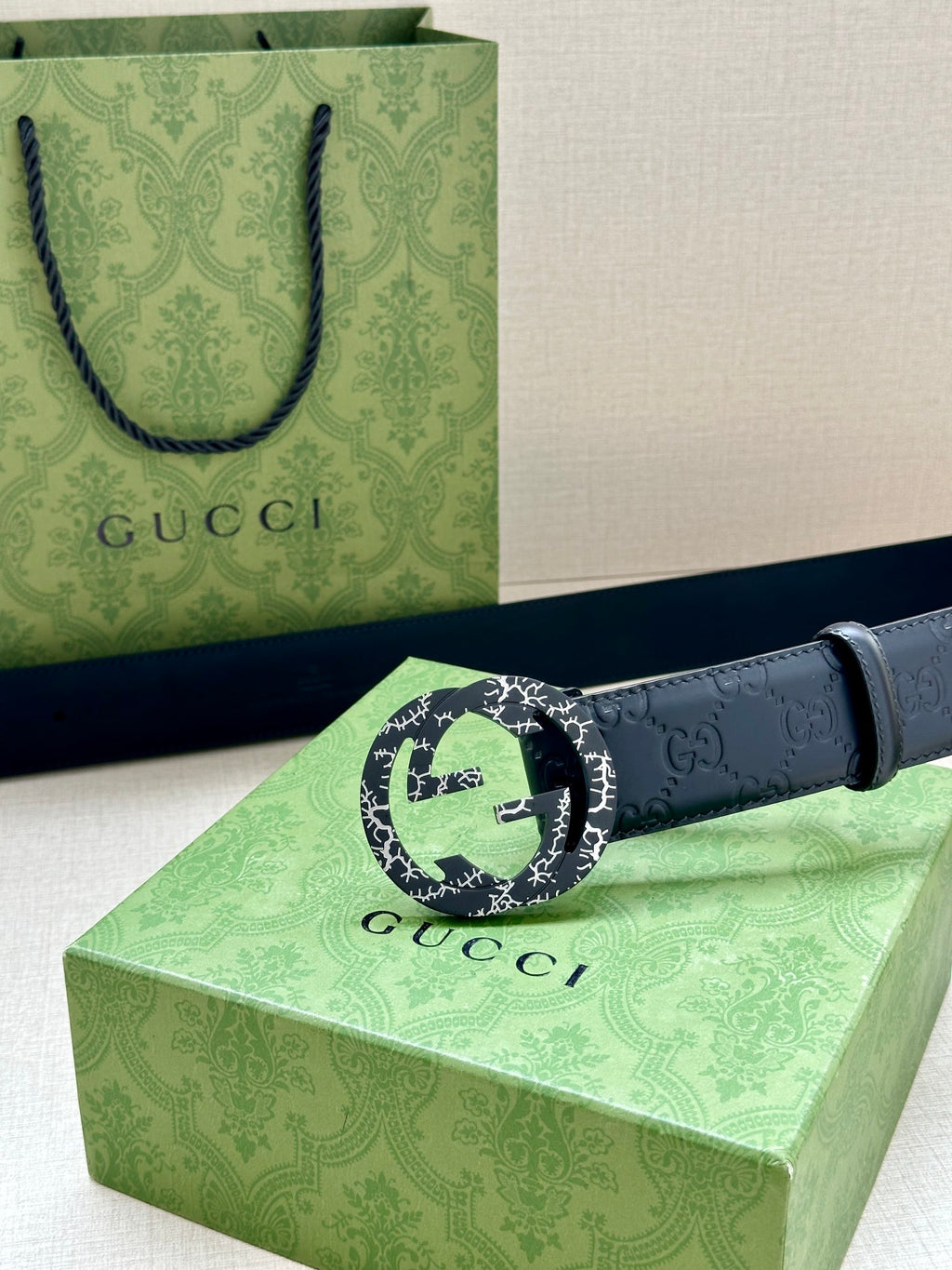 Gucci belt with dark blue embossed leather and a large round logo buckle