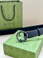 Gucci belt with dark blue embossed leather and a large round logo buckle
