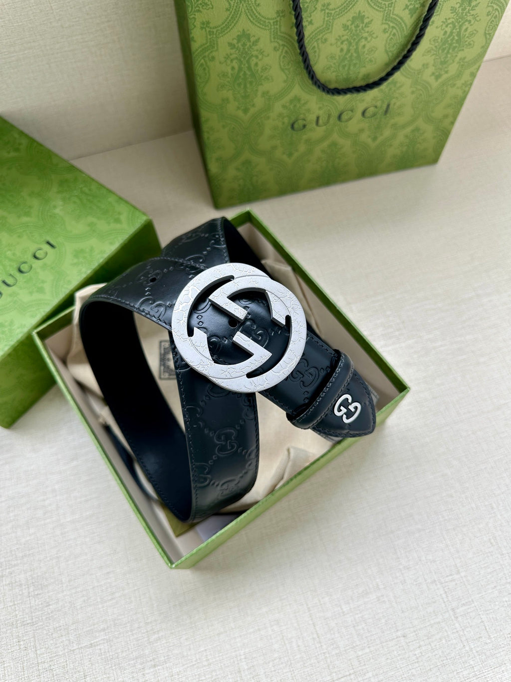Gucci belt in a gift box, dark blue embossed leather with a large round logo buckle