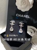 Silver-tone teardrop crystal drop earrings with winged motif studs