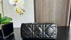 Quilted black handbag front view with two top handles and gold-tone accents
