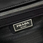 Prada Milano label on black bag zipper tape with silver teeth and stitched trim.