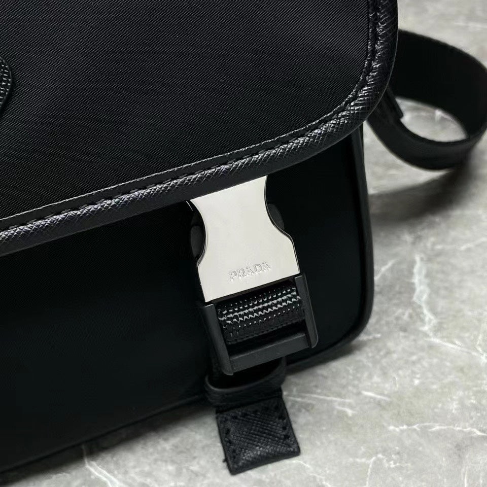 Prada black bag corner with adjustable strap buckle and interior tag visible.