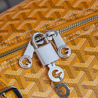 Metal zipper pull and lock hardware on yellow patterned duffel bag