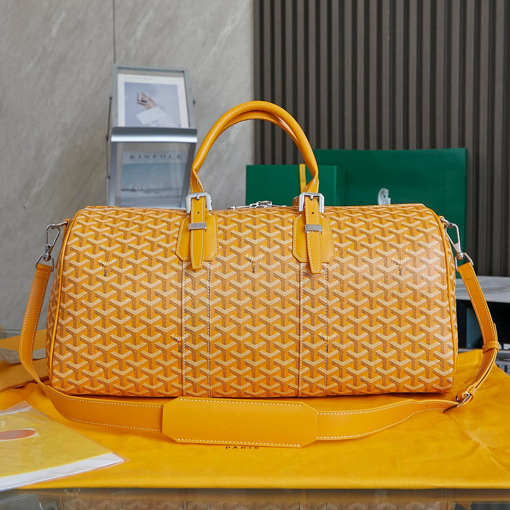 Goyard duffel bag with yellow patterned canvas, double top handles, side straps