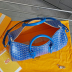 Goyard blue patterned duffle bag open top showing orange interior