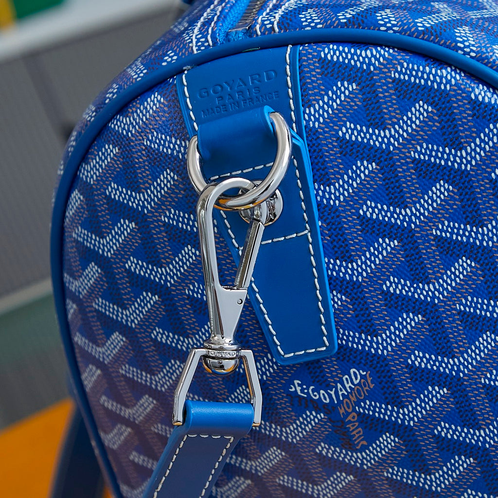 Goyard blue monogram duffle bag close-up: top handle and metal clip