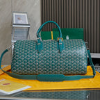 Goyard bag in teal with white pattern, structured top handles and long shoulder strap