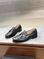 Prada unisex black loafers, angled pair view with bar strap detail