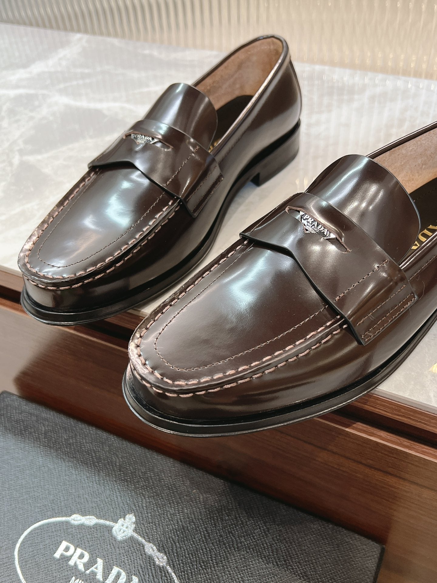 Prada unisex leather loafers, dark brown, pair with side penny strap detail