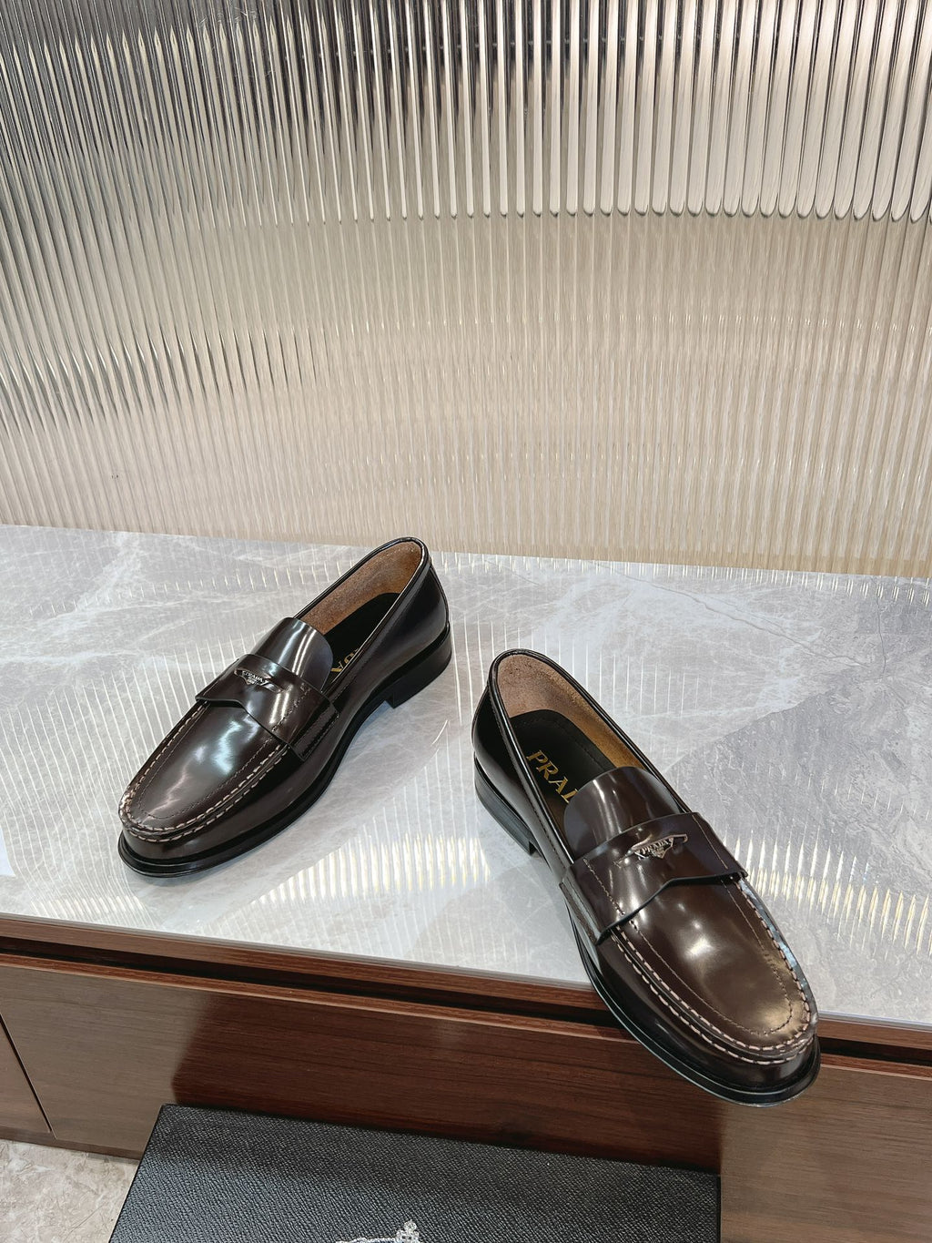 Prada unisex leather loafers, dark brown, side view with penny strap