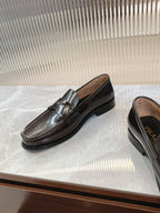 Prada unisex leather loafers, dark brown, angled on display