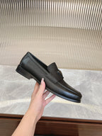 Prada unisex leather loafer, dark textured upper, slip-on style, side metal emblem