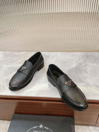 Prada unisex loafers, dark textured leather, slip-on style with metal side logo